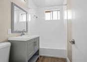 Thumbnail 34 of 38 - a bathroom with a sink and a shower and a toilet