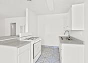 Thumbnail 1 of 38 - a kitchen with white cabinets and a sink and a stove
