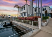 Thumbnail 127 of 135 - a house overlooking a body of water with a sunset in the background