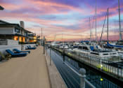 Thumbnail 128 of 135 - a marina at sunset with boats in the water and a house on the side of the