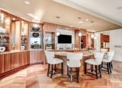 Thumbnail 27 of 95 - a kitchen with a large island with bar chairs and a tv