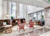 Thumbnail 21 of 95 - a lobby with chairs and couches and large windows