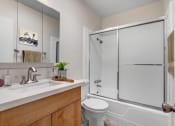 Thumbnail 6 of 25 - a bathroom with a toilet sink and shower