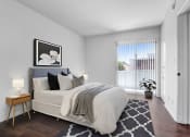 Thumbnail 4 of 25 - a bedroom with a large bed and a large window