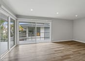 Thumbnail 5 of 208 - A room with a sliding glass door leading to a balcony.