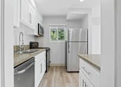 Thumbnail 3 of 208 - A modern kitchen with stainless steel appliances and white cabinets.