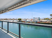 Thumbnail 32 of 208 - A view from a bridge looking out over a calm body of water.
