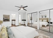 Thumbnail 13 of 228 - A bedroom with a bed, a couch, and a ceiling fan.