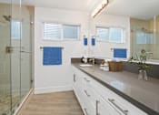 Thumbnail 12 of 228 - A bathroom with a walk-in shower and double sinks.