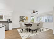 Thumbnail 5 of 228 - A modern dining room with a table set for four.