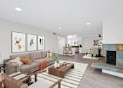 Thumbnail 6 of 228 - A living room with a grey couch and a coffee table.