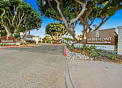 Thumbnail 163 of 208 - A sign for Waterfront Apartments sits in front of a tree.