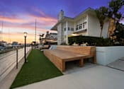 Thumbnail 202 of 208 - A modern house with a wooden deck in front.