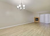 Thumbnail 12 of 25 - A room with wooden flooring and a chandelier.