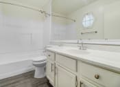 Thumbnail 15 of 17 - a bathroom with a sink toilet and a bath tub