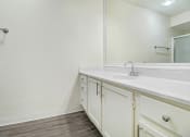 Thumbnail 17 of 17 - a bathroom with white cabinets and a sink and a mirror