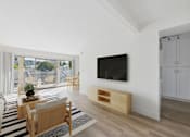 Thumbnail 8 of 20 - A modern living room with a flat screen TV mounted on the wall.
