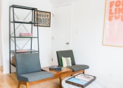 Thumbnail 3 of 10 - a living room with two chairs and a coffee table