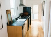 Thumbnail 5 of 10 - a kitchen with a sink and a stove and a refrigerator