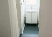Thumbnail 8 of 10 - a small bathroom with a sink and a window
