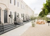 Thumbnail 9 of 10 - the outside of a building with a picnic table and benches