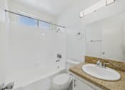 Thumbnail 5 of 64 - A white bathroom with a toilet, sink, and tub.