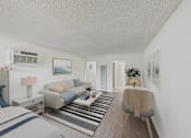 Thumbnail 4 of 64 - A living room with a grey couch and a striped rug.