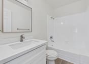 Thumbnail 20 of 74 - A white bathroom with a sink, toilet, and bathtub.