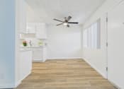 Thumbnail 13 of 74 - A kitchen with white cabinets and a ceiling fan.