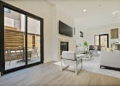 Thumbnail 15 of 59 - a living room with a fireplace and sliding glass doors