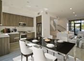 Thumbnail 14 of 59 - a large kitchen and dining room with a black table and chairs