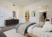 Thumbnail 8 of 59 - a bedroom with a large bed and a closet and a bathroom