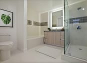 Thumbnail 11 of 59 - a bathroom with a shower and a sink and a toilet