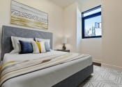 Thumbnail 9 of 59 - a bedroom with a large bed and a window