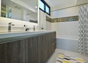 Thumbnail 20 of 59 - a bathroom with a long counter and a large mirror