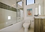 Thumbnail 21 of 59 - a white bathroom with a toilet and a shower