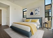 Thumbnail 6 of 59 - a bedroom with a bed and a large window