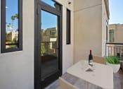 Thumbnail 4 of 59 - a patio with a table and a bottle of wine on it