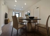 Thumbnail 2 of 59 - a dining room with a table and chairs and a tv