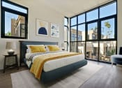 Thumbnail 7 of 59 - a bedroom with a bed and a large window