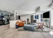 Thumbnail 7 of 27 - a spacious living room with white walls and hardwood flooring