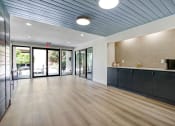 Thumbnail 7 of 24 - a lobby with a blue ceiling and wood flooring