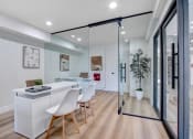 Thumbnail 11 of 24 - a dining area with a table and chairs and a sliding glass door