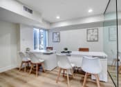 Thumbnail 10 of 24 - a white office with a white desk and chairs