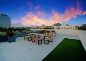 Thumbnail 33 of 39 - a seating area on the roof of a building at sunset