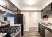 Thumbnail 56 of 63 - Kitchen with Stainless Steel Appliances in the Two Bedroom Two Bath Apartment at Woodbridge Apartments Bloomington