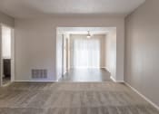 Thumbnail 48 of 63 - Dining Room with Patio Access and Living Room in the Two Bedroom Townhome at Woodbridge Bloomington