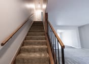 Thumbnail 44 of 63 - Stairway in the Two Bedroom Townhome at Woodbridge Apartments Bloomington