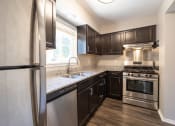 Thumbnail 42 of 63 - Kitchen with Stainless Steel Appliances in the Three Bedroom Townhome at Woodbridge Apartments Bloomington