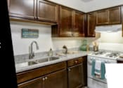 Thumbnail 14 of 14 - A kitchen interior with a sign that says "Limited Availability! Schedule a tour today to learn more about our 1 & 2 bedroom apartment homes and 2 & 3 bedroom townhomes."